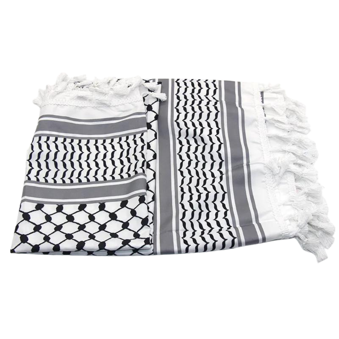 A white keffiyeh (traditional Palestinian headscarf) folded neatly on display. The scarf features a classic pattern of interwoven lines and geometric shapes, symbolizing cultural identity and resistance. The material appears soft and lightweight, perfect for both fashion and practical use. This keffiyeh is part of the "Shadow Resurgence" collection, emphasizing its modern, bold aesthetic while honoring its deep historical roots.