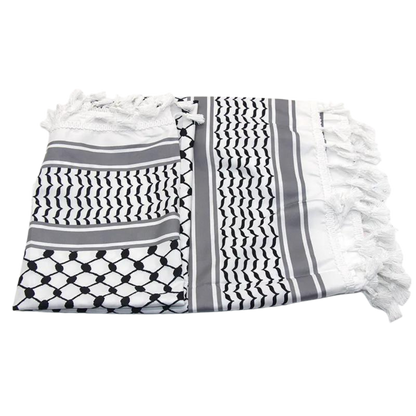 A white keffiyeh (traditional Palestinian headscarf) folded neatly on display. The scarf features a classic pattern of interwoven lines and geometric shapes, symbolizing cultural identity and resistance. The material appears soft and lightweight, perfect for both fashion and practical use. This keffiyeh is part of the "Shadow Resurgence" collection, emphasizing its modern, bold aesthetic while honoring its deep historical roots.