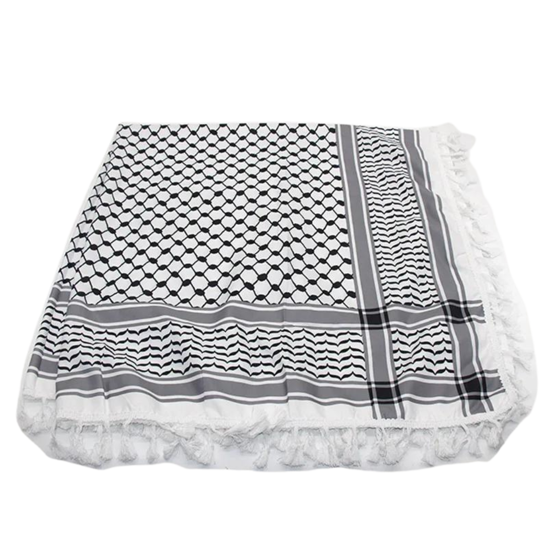 A white keffiyeh (traditional Palestinian headscarf) folded neatly on display. The scarf features a classic pattern of interwoven lines and geometric shapes, symbolizing cultural identity and resistance. The material appears soft and lightweight, perfect for both fashion and practical use. This keffiyeh is part of the "Shadow Resurgence" collection, emphasizing its modern, bold aesthetic while honoring its deep historical roots.